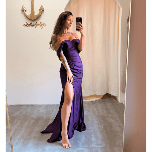 Model in einem dunkelvioletten Off-Shoulder Kleid mit Beinschlitz – Vorderansicht.